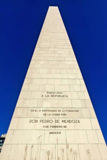 Close-up of an obelisk with engraved inscriptions against a clear blue sky, The great obelisk in