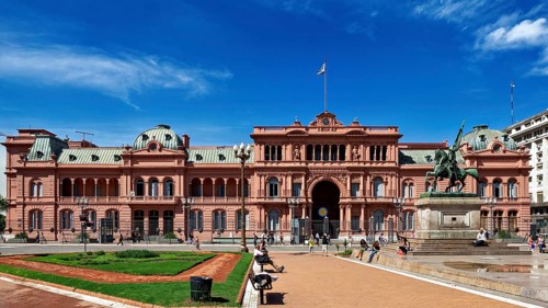 Historic building with equestrian monument and blue sky in the background, famous landmark in