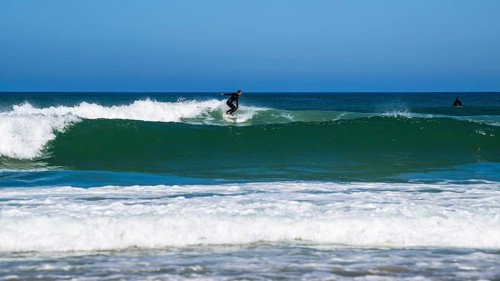 Surfer riding a wave on Contis beach, Saint Julien en Born, Saint-Julien-en-Born, Landes, France