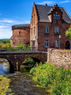The old town centre with the town wall and the Seemenbach stream, Büdingen, Hesse, Germany