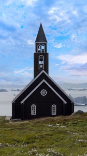 Typical architecture of Greenland Ilulissat with colored houses located near fjords and icebergs