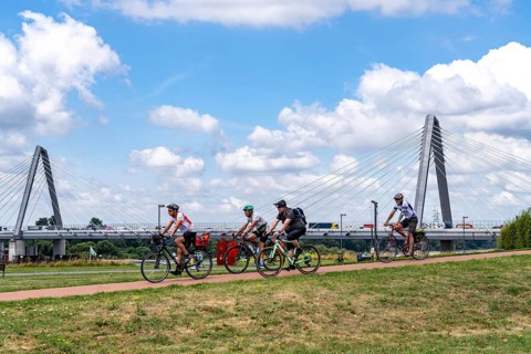 Cycle path in the Neulandpark in Leverkusen on the Rhine, in the background the new Rhine bridge of