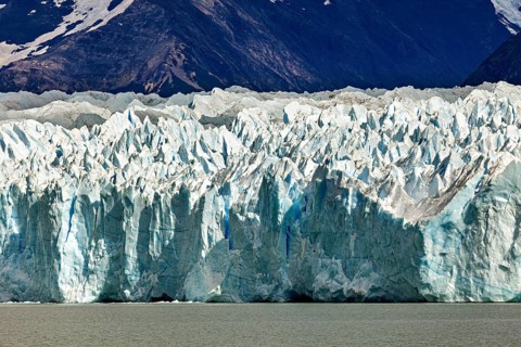 Detailed view of a massive blue glacier against a mountain backdrop, The Perito Moreno glacier in