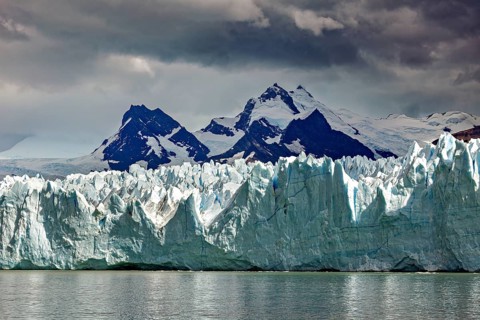 Imposing glacier merges with snow-covered mountains and sky, The Perito Moreno glacier in Argentina