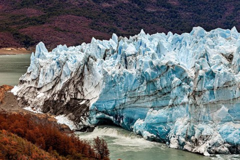 Massive glacier with blue peaks and autumnal foreland, The Perito Moreno glacier in Argentina