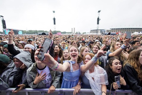 Festival visitors celebrate Mark Ambor's performance at the Lollapalooza Festival in the