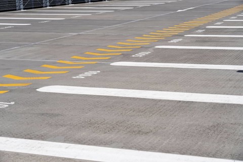 Markings on a car park deck, Direction of travel marking, Numbered parking spaces, Graphic