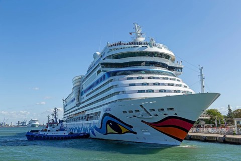 Cruise ship AIDAmar is pushed against the quay wall by tugboats, Warnow, Warnemünde, Rostock,