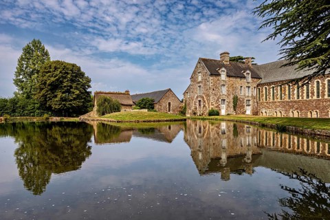 Historic castle on the shore of a lake with a clear reflection and surrounded by trees, The Abbey