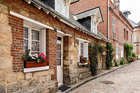 Picturesque old town street with half-timbered houses and blooming flowers in the window boxes, The