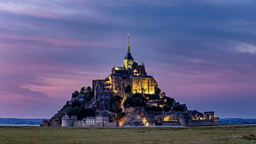 Mont Saint-Michel at sunset with lighting and coloured sky, Mont Saint Michel in Normandy, France
