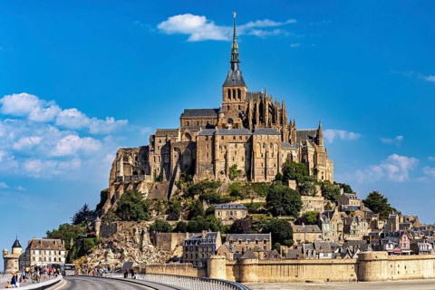 The historic monastery of Mont Saint-Michel against a bright blue sky, Mont Saint Michel in
