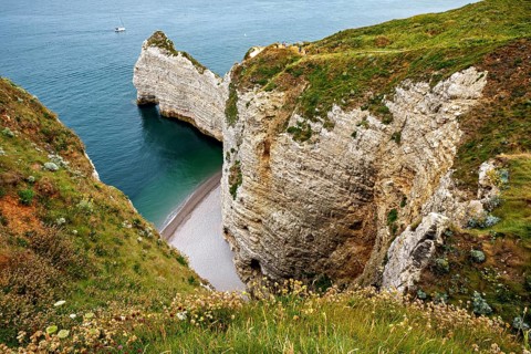 Deep coastal gorge with shallow beach and steep cliffs, The cliffs and alabaster coast of Etretat