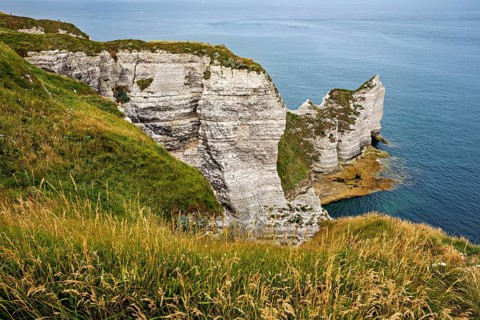 Rugged coastal terrain with impressive white cliffs and grass, The cliffs and alabaster coast of