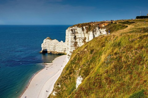 Panoramic view of the coastline with green cliffs and blue sea in sunny weather, The cliffs and