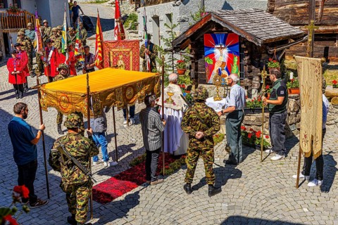 The priest celebrates a service at the flower-decorated altar during the Corpus Christi procession,