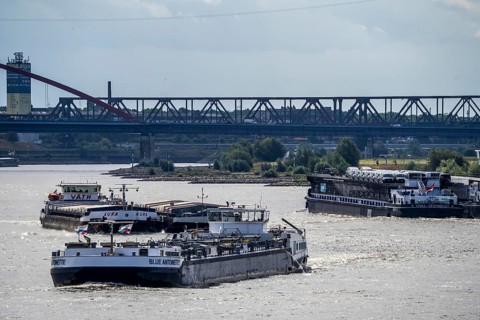 Cargo ships on the Rhine, in the background the Rhine bridge near Duisburg-Rheinhausen, Bridge of