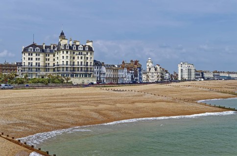 Beach and building on the seafront in Eastbourne, seaside resort on the English Channel, in the