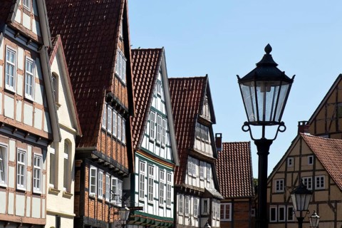 Street with half-timbered houses and historic street lamp in the old town centre, Celle, Lower