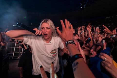 Emily Armstrong, lead singer of Linkin Park in the photo pit between the audience live on From Zero