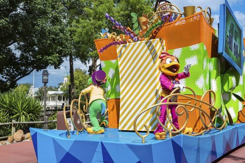 Disney character riding on float during parade through the Frontierland area of Magic Kingdom at
