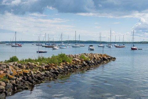 Sailing boats in the harbour, stone jetty, dark clouds, Eckernförde, Baltic Sea,