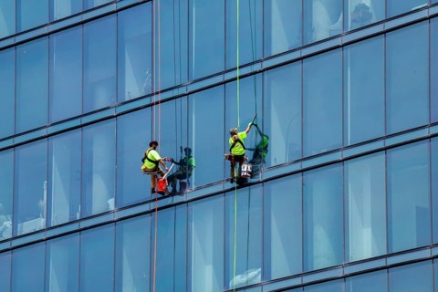 Detroit, Michigan - Window washers at the 25-story Residences Water Square luxury apartment