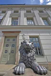 Head of lion figure and entrance to historic lion building, front door, palace, modern art,