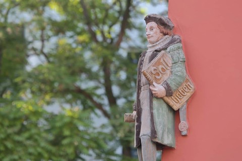 Historical merchant from the 16th century with book and inscription Soll Haben, created in 1933,