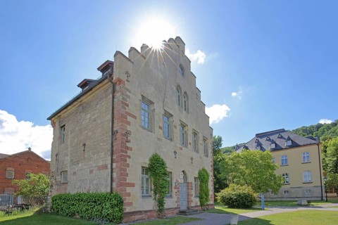 Gothic house with stepped gable in the backlight of the former Cistercian abbey and today's