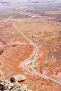 Winding roadway cutting through Valley of the Gods, Utah, USA
