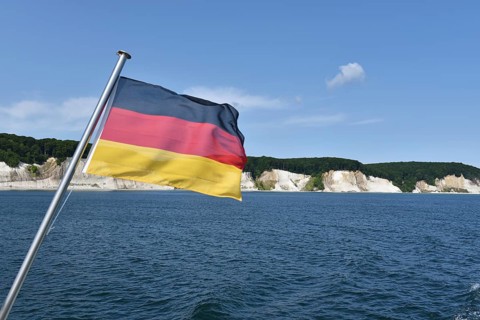 German flag in front of the chalk cliffs on Rügen, Mecklenburg-Western Pomerania, Germany