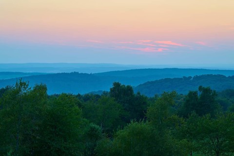 Pink evening sky over a gentle hilly landscape, peaceful nature, Geishöhe, Dammbach, Spessart,