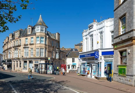 Street and shops including WH Smith in town centre of Teignmouth, south Devon, England, UK