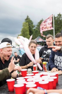 Festival visitors play a drinking game on a campsite at the Rock am Ring Festival on Saturday,