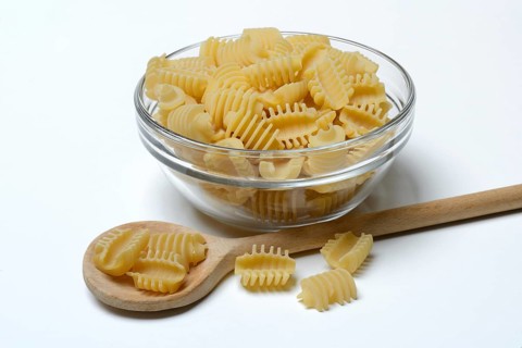 Italian pasta in a glass bowl, Radiatori variety