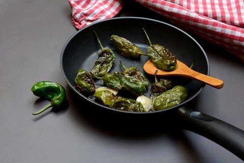Pan-fried pimientos de padron in olive oil, roast peppers