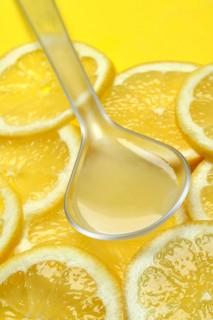 Lemon juice in ladle and lemon slices, Citrus x limon