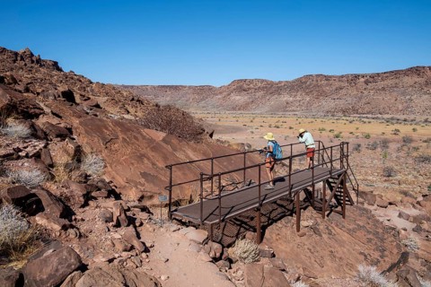 Tourists on a platform at the rock engravings of Twyfelfontein, Twyfelfontein, Kunene, Namibia
