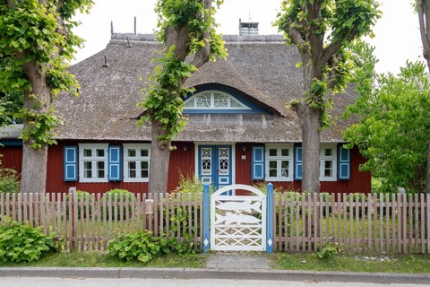Picturesque thatched house with blue shutters, Wieck, Mecklenburg-Vorpommern, Germany