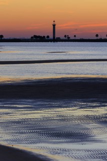 Sunrise silhouette of Broadwater Beach Marina Light at Biloxi, Mississippi, USA