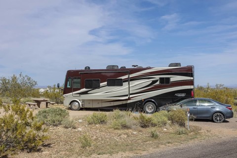 Motorhome parked at a desert campsite at the White Tank Mountain Regional Park campground in