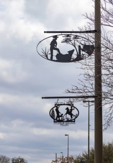 Artistic metal signs showing cowboy life on poles in Bandera, Texas, USA