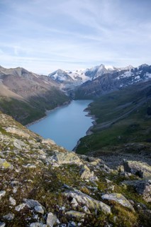 View at the summit of Mont de la Blana, view of a blue mountain lake, Lac des Dix reservoir, behind