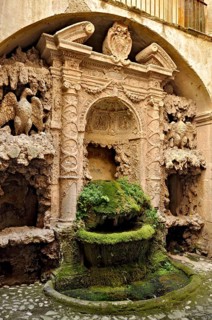 Ornamental fountain from the Renaissance, fountain with moss and artificial dripstone from the