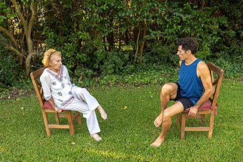 Physiotherapist guides a senior woman through gentle rehabilitation exercises, focusing on mobility
