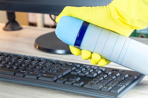 Office cleaning: Close-up of the cleaning of an office desk