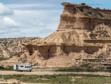 Camper van, desert, rock formation Tozal Colasico, colorful sandstone, gravel road Ruta Jubierre,