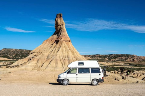 Camper van in front of Castildetierra rock formation, semi-desert, Bardena Blanca area, Bardenas