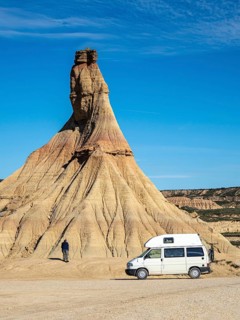Camper van in front of Castildetierra rock formation, tourist, semi-desert, Bardena Blanca area,